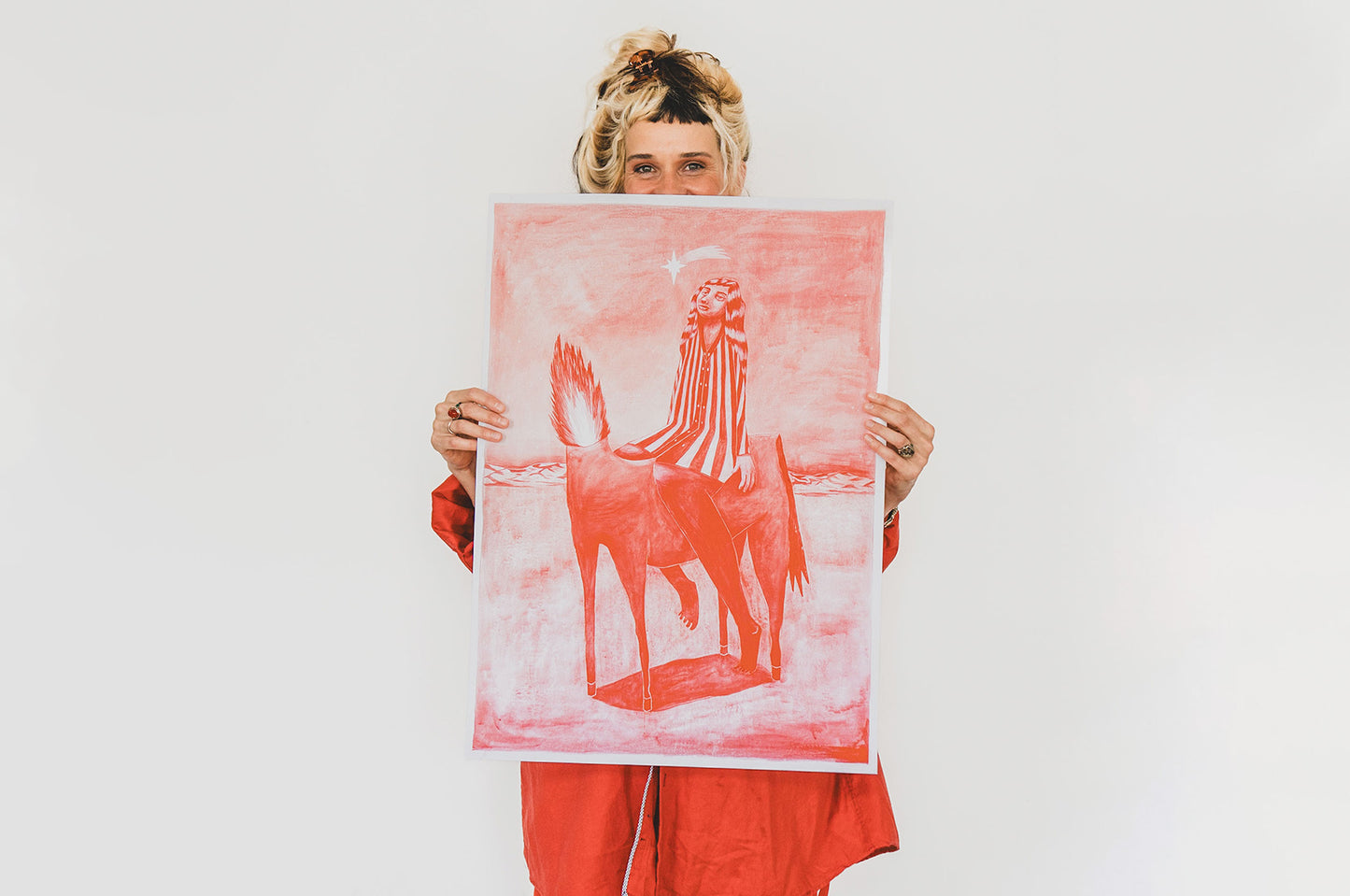 Artwork scale view – person holding print by Mag Magrela