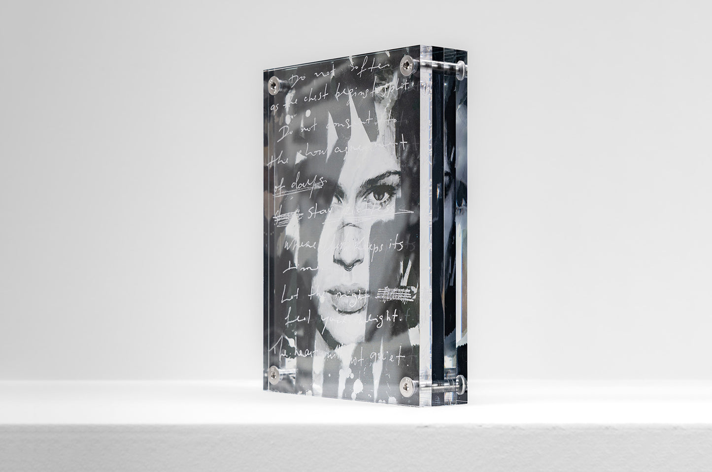 Angled perspective of acrylic artwork with layered reflections