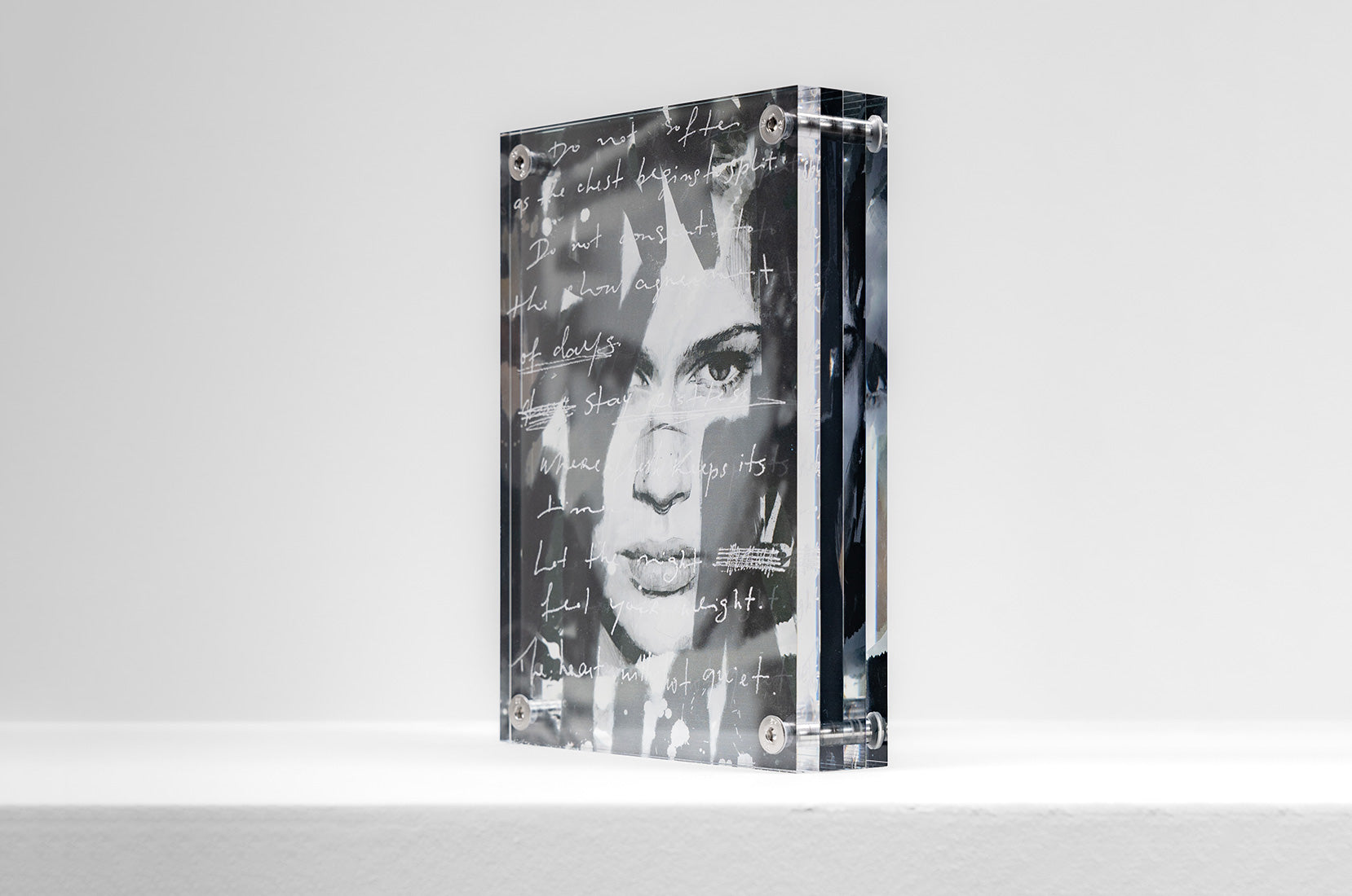 Angled perspective of acrylic artwork with layered reflections