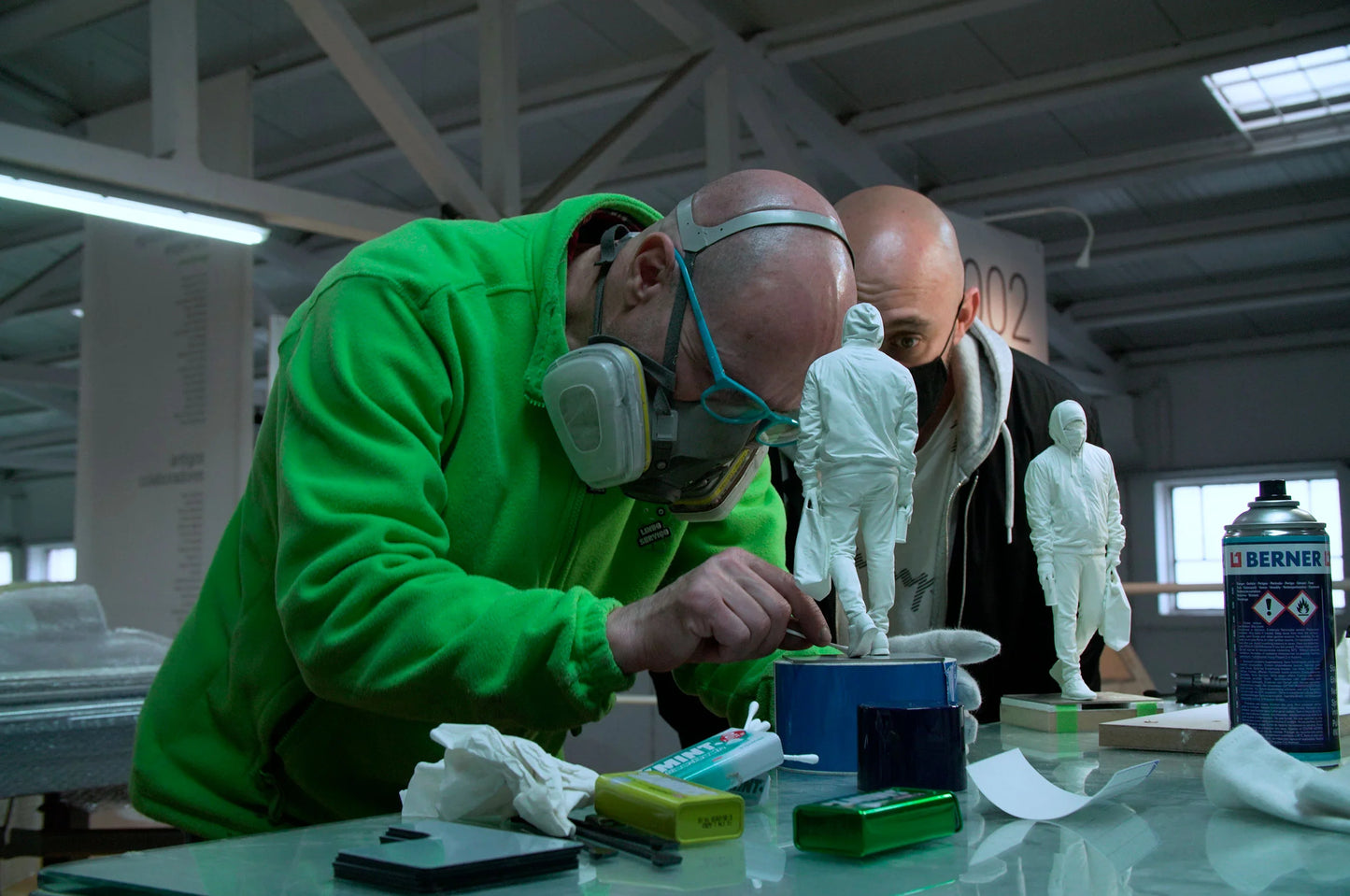 Studio production process of Writer III sculpture by Nuno Viegas with hands working on resin model