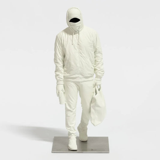 Writer III sculpture by Nuno Viegas showing a full resin figure walking with a bag on a steel base